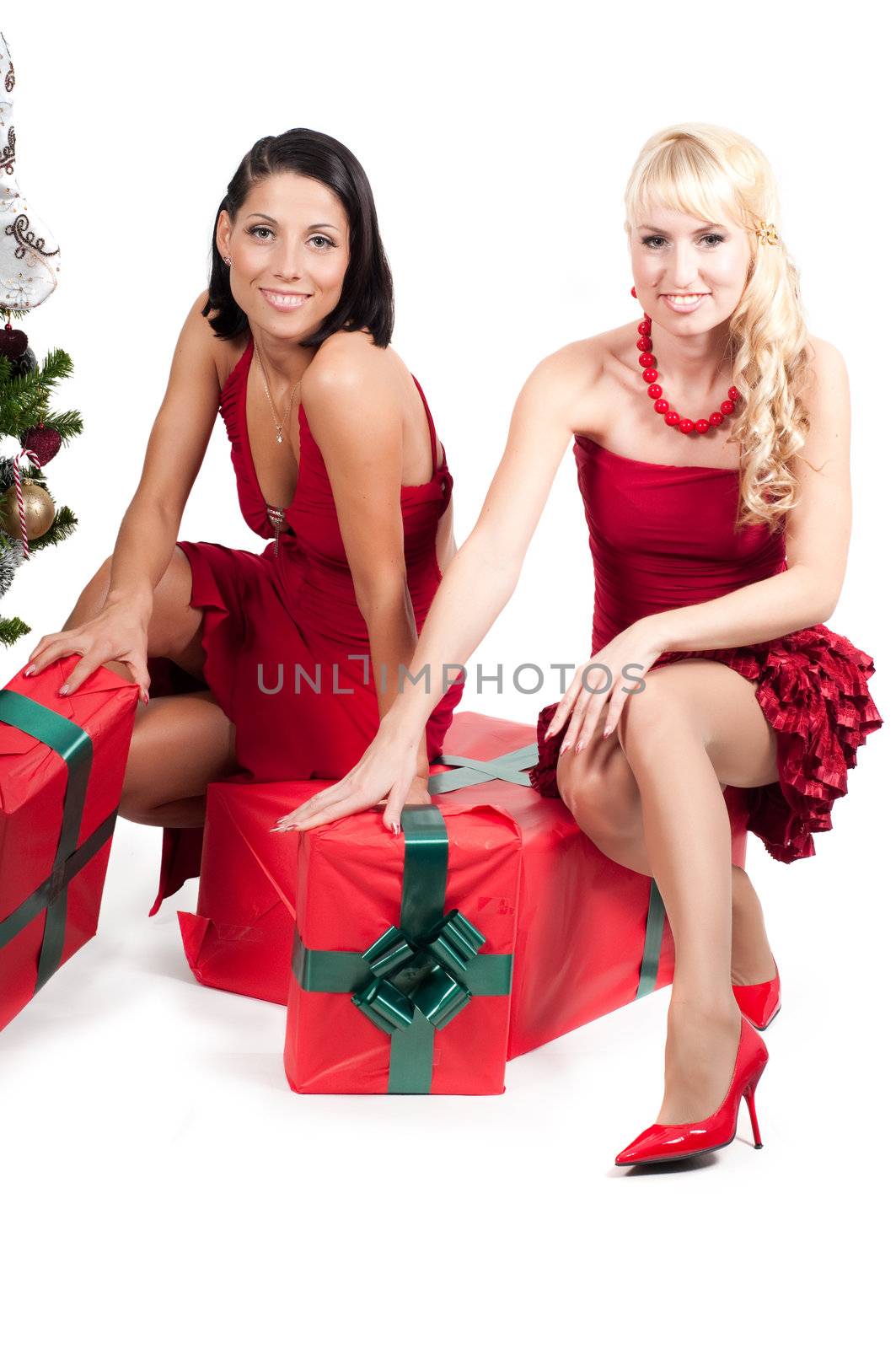 Happy women with Christmas presents and tree isolated on white