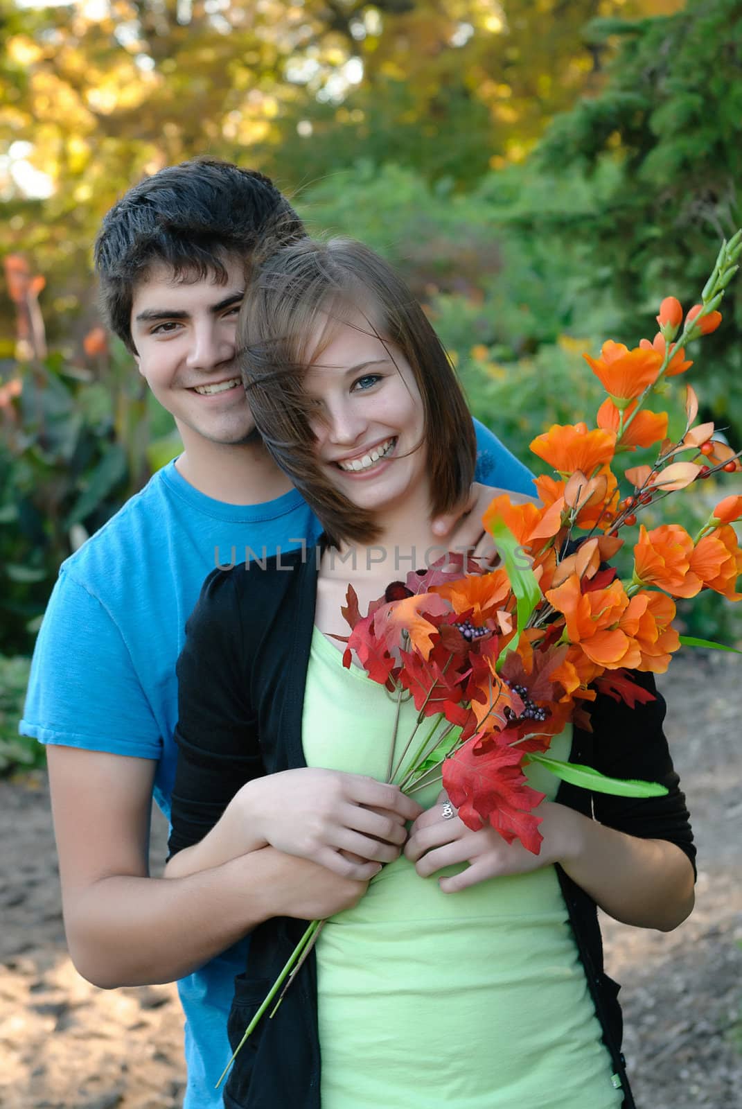 A young couple smiling during the fall
