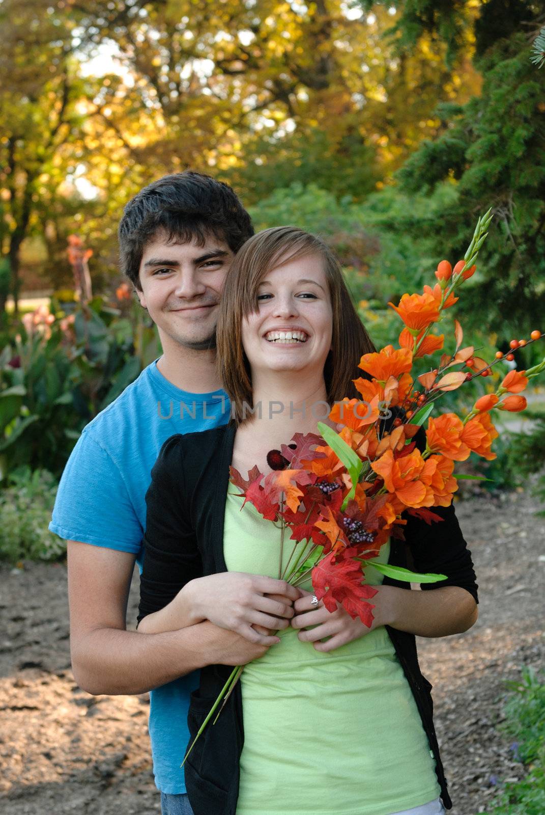 A young couple laughing and smiling during the fall