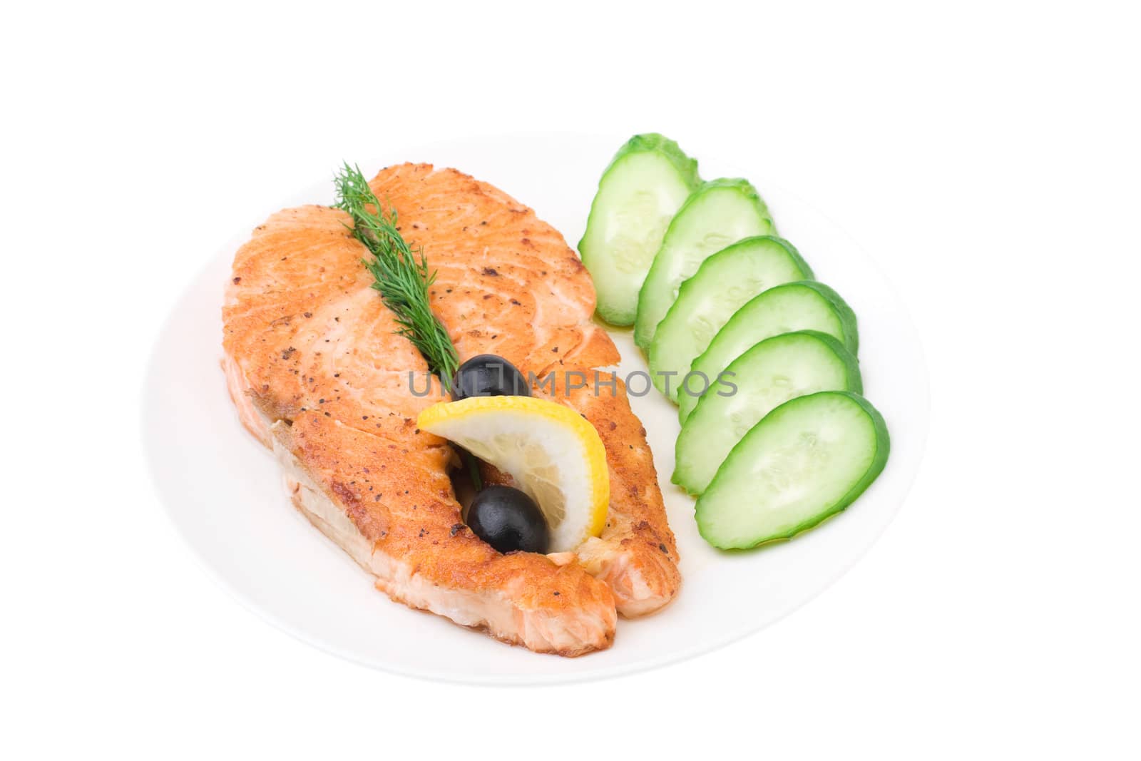Appetizing Grilled Salmon with sliced cucumber, lemon and black olives isolated over white