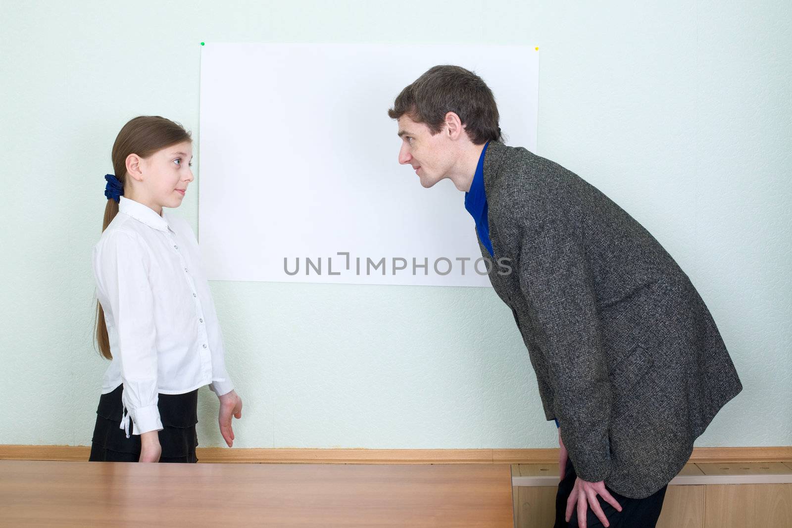 Tutor explains something to the little girl