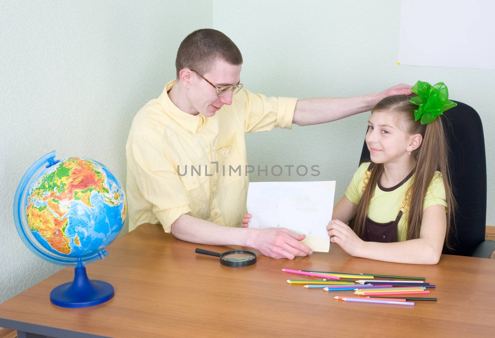 The girl shows new drawing to the brother