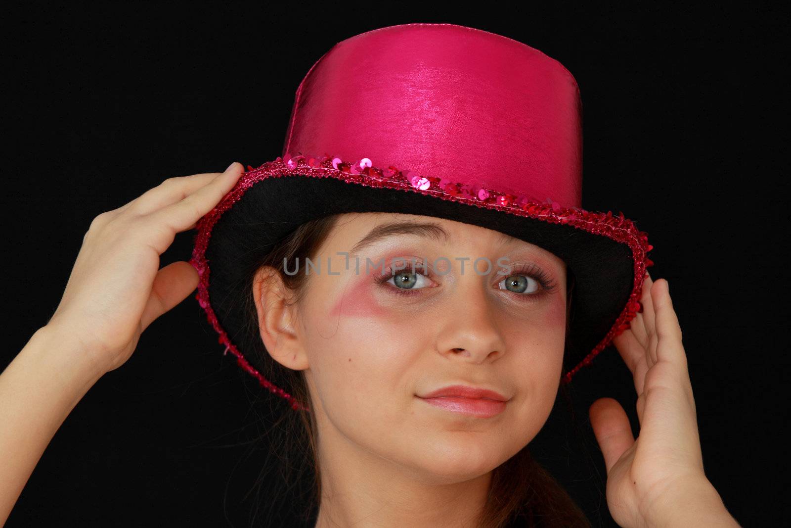 Portrait of a beautiful young girl in pink disco hat - carnival theme