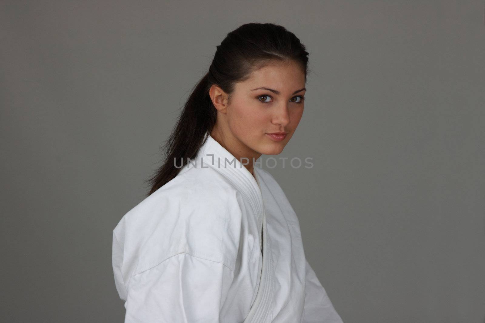Beautiful young teen in karate suit