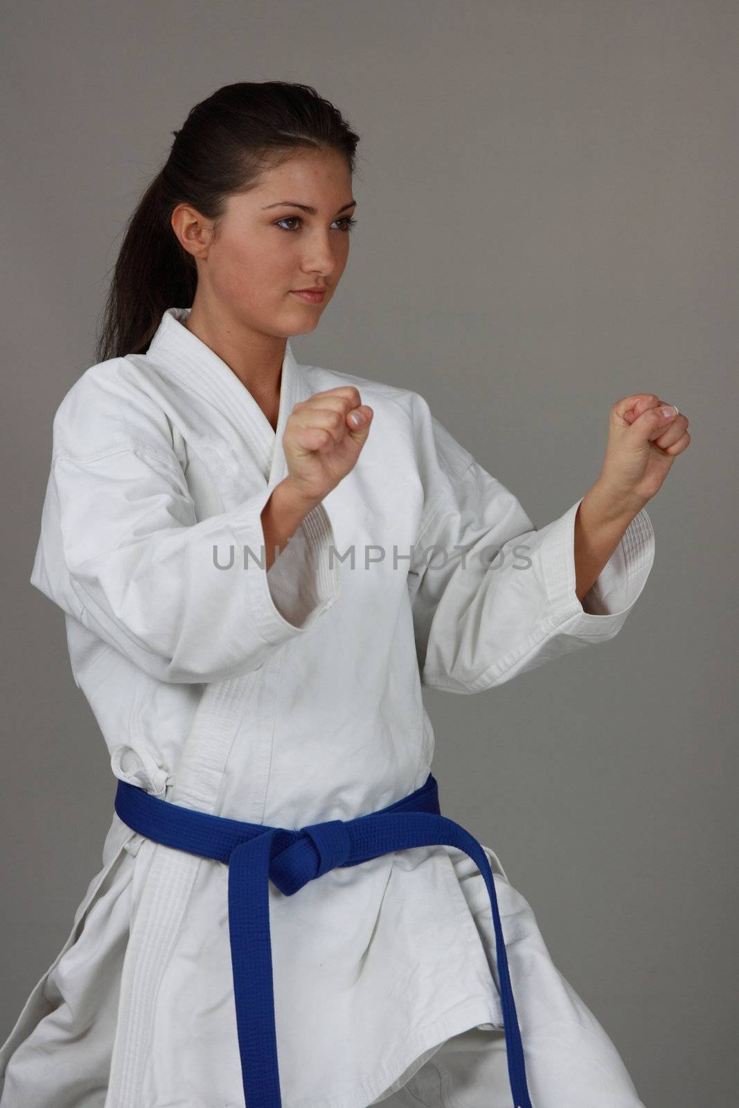 Beautiful young teen in karate suit