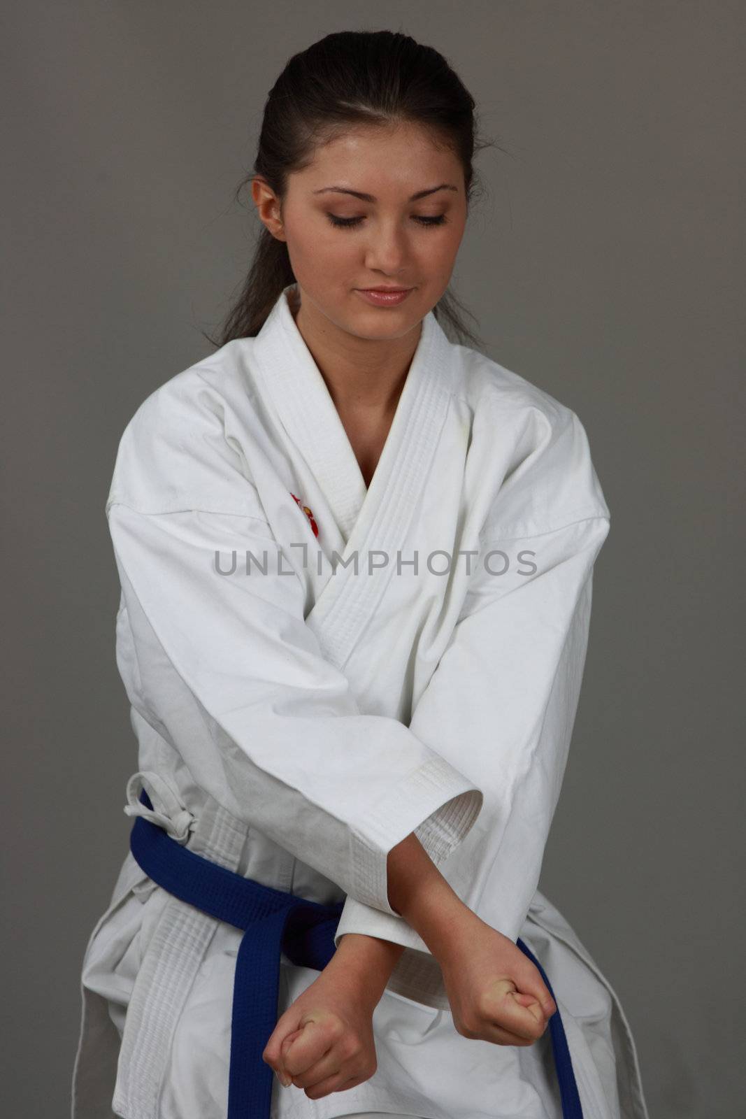 Beautiful young teen in karate suit