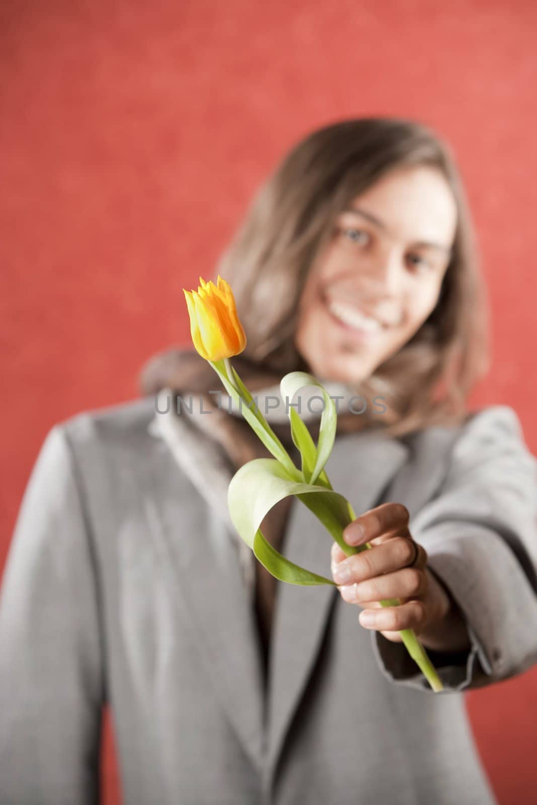 Closeup Portrait of a Handsome Young Man with Yellow Tulip