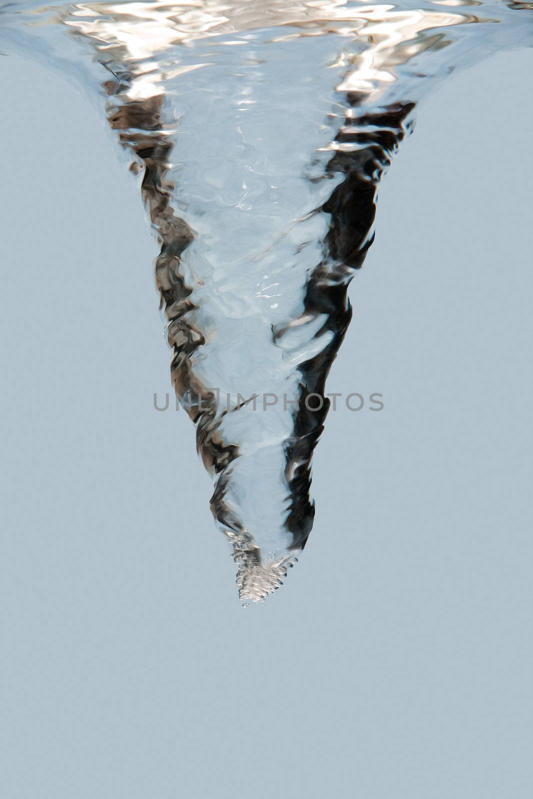 Side view of an underwater vortex swirl with bubbles, isolated