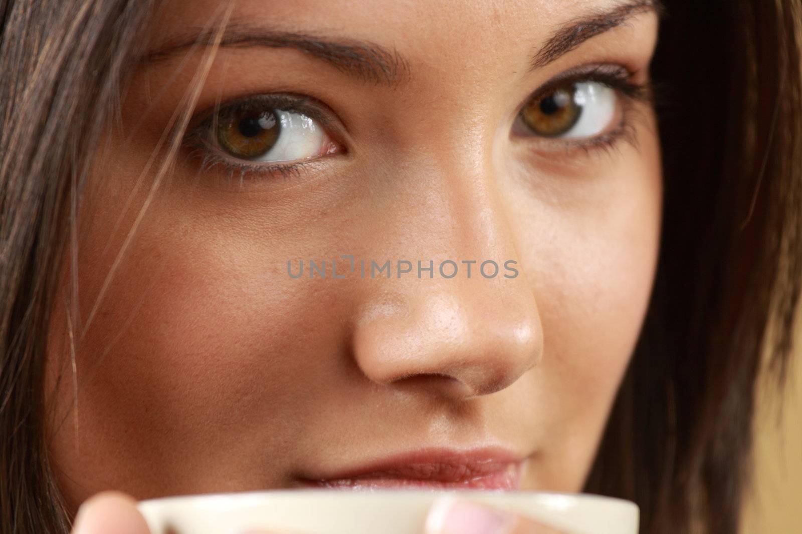 Young woman with beautiful face is having her tea/coffee by BDS