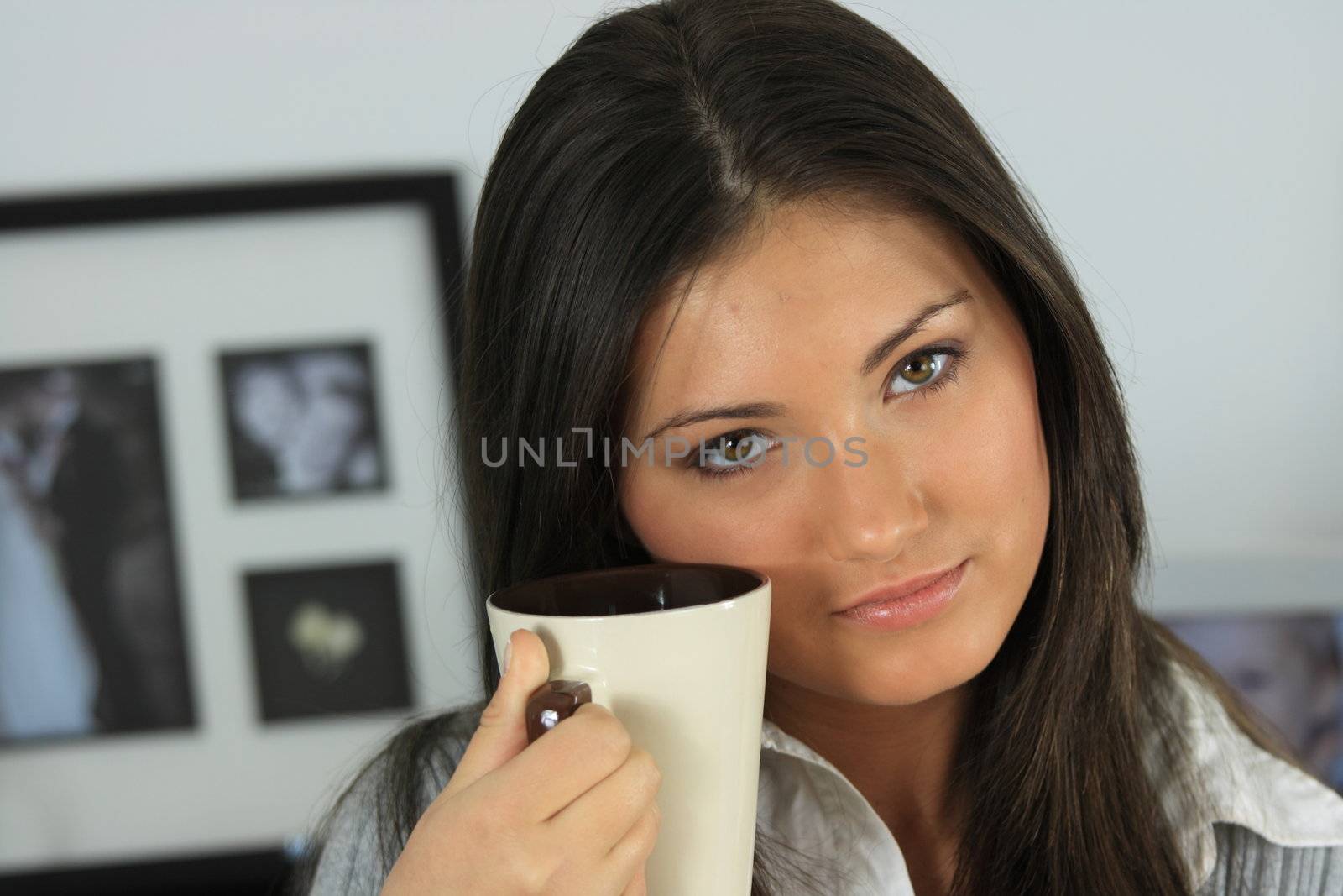 Young woman with beautiful face is having her tea/coffee by BDS