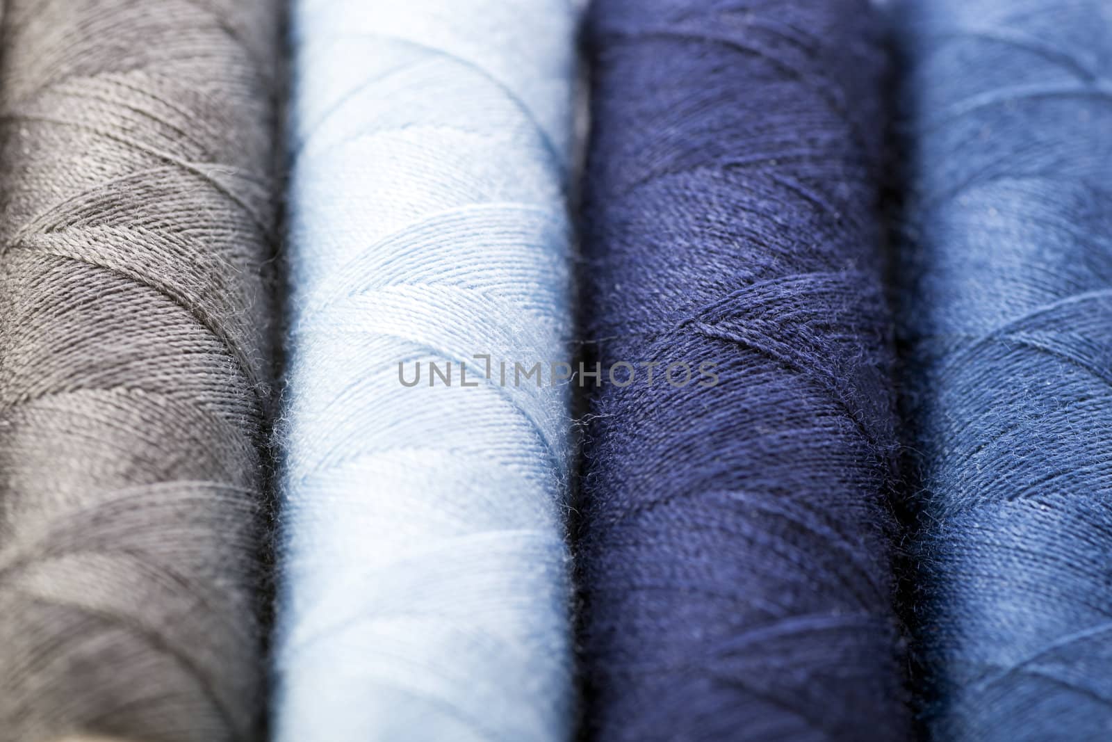 Cotton threads in shades of blue and gray.