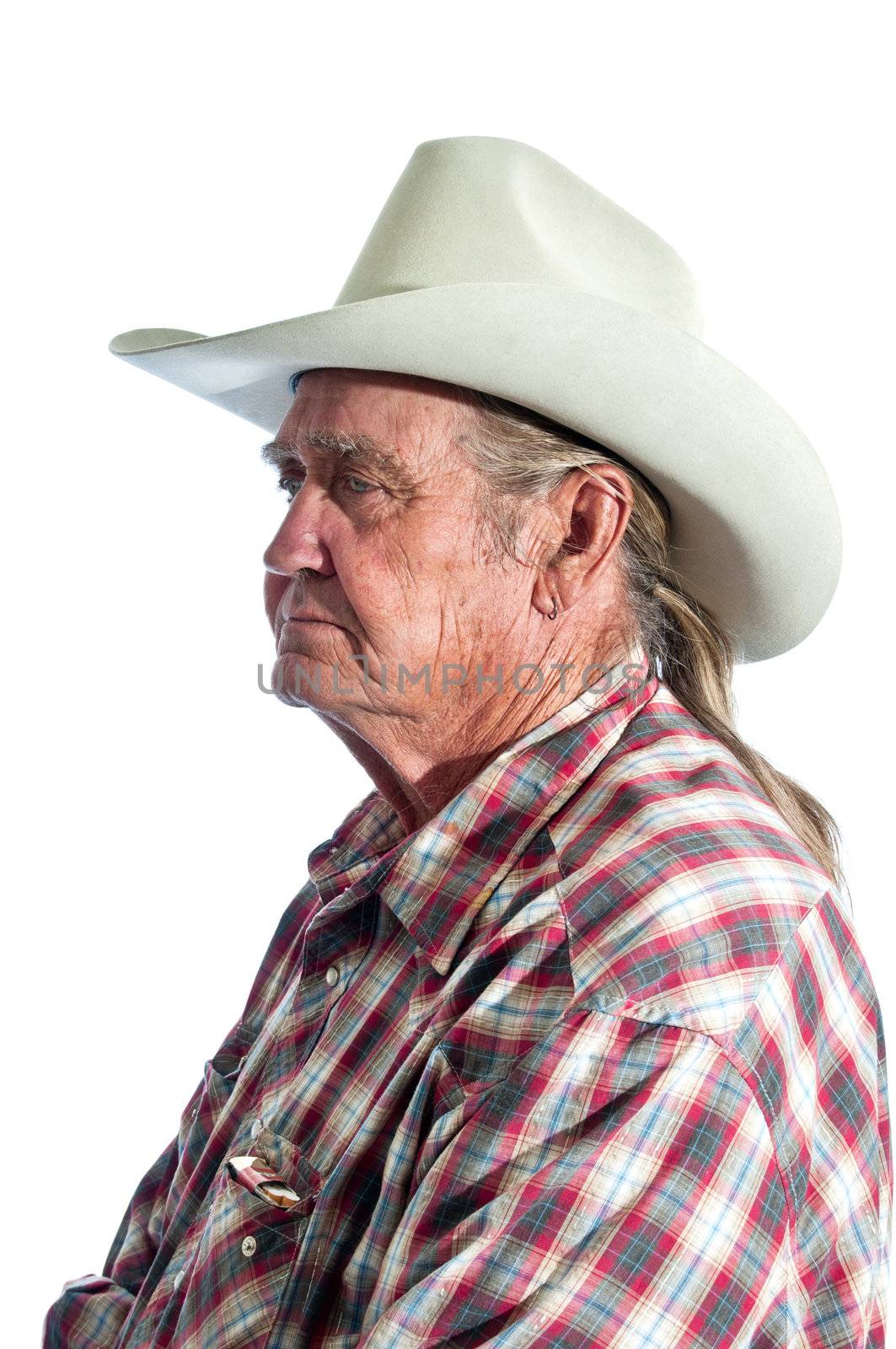 Wisdom written upon his face, a retired  cowboy pauses long enough for a portrait.