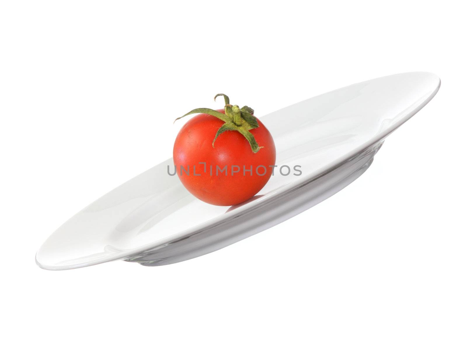 Tomato on plate isolated on white background