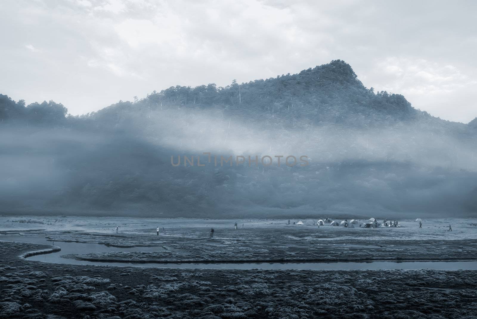 It is a river with mist and mountain.