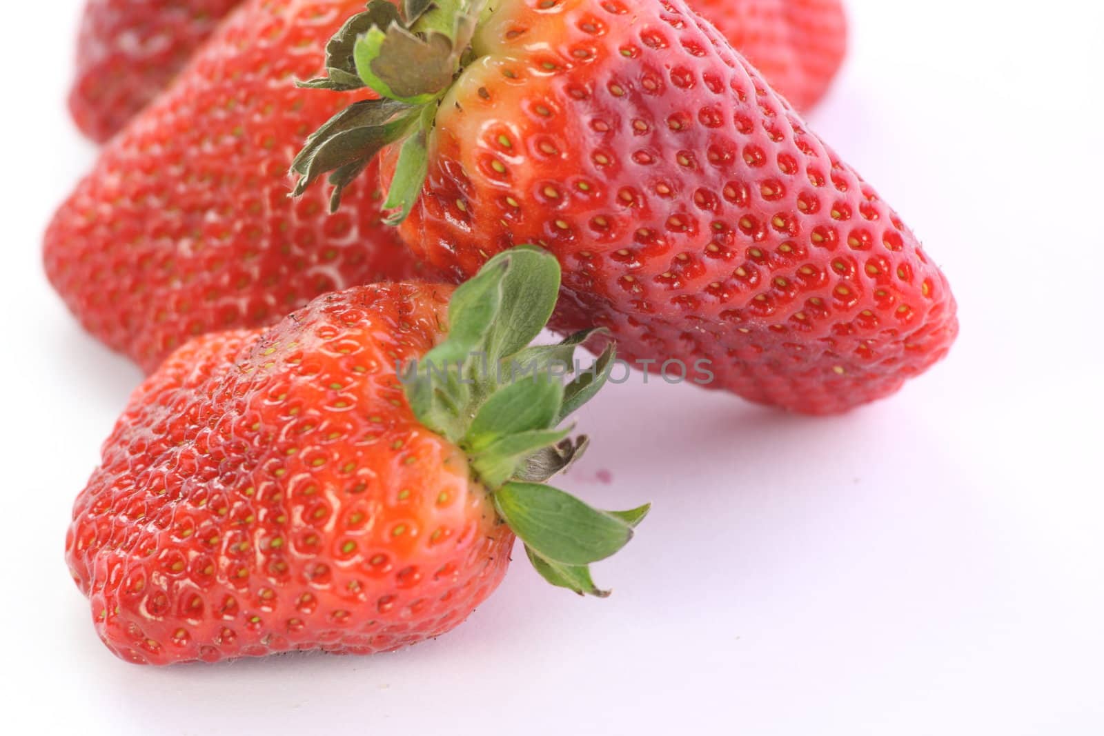 Strawberries over white background by BDS