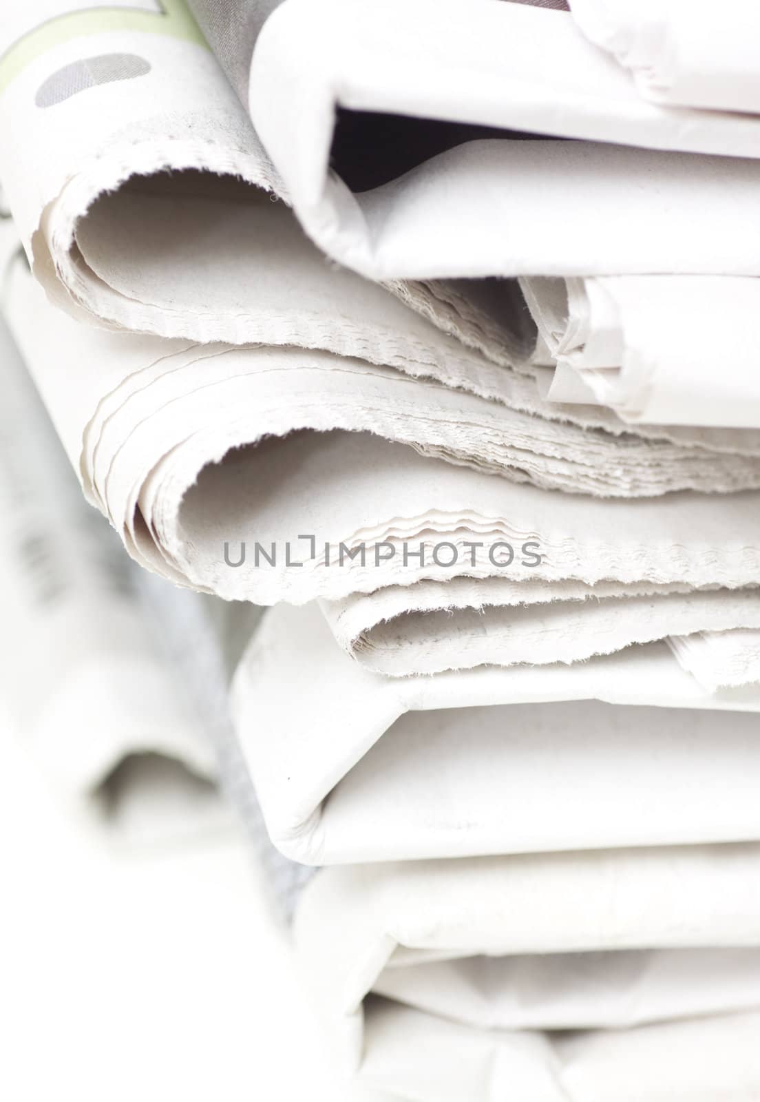 pile of newspapers on white table

