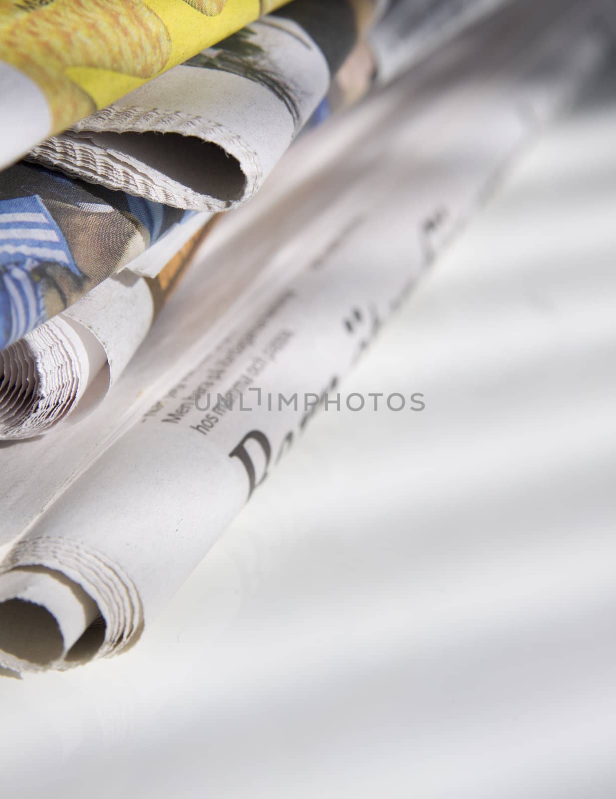pile of newspapers on white table