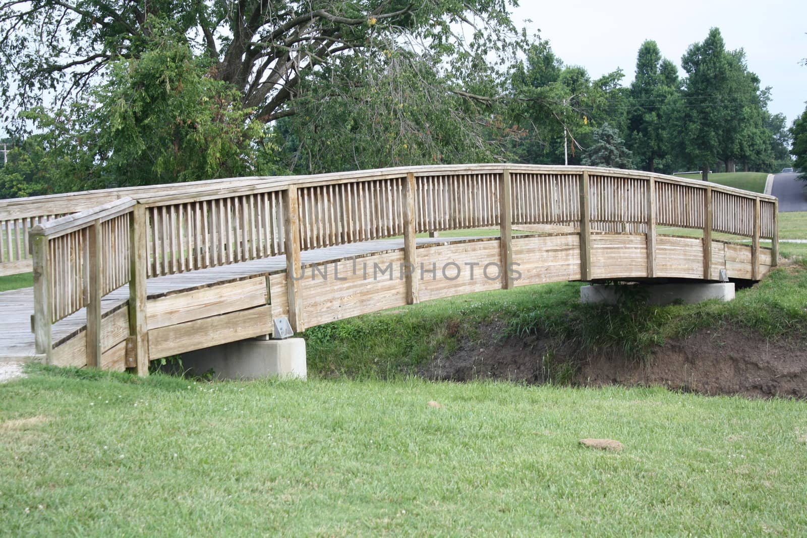 a wooden bridge over a  small creek