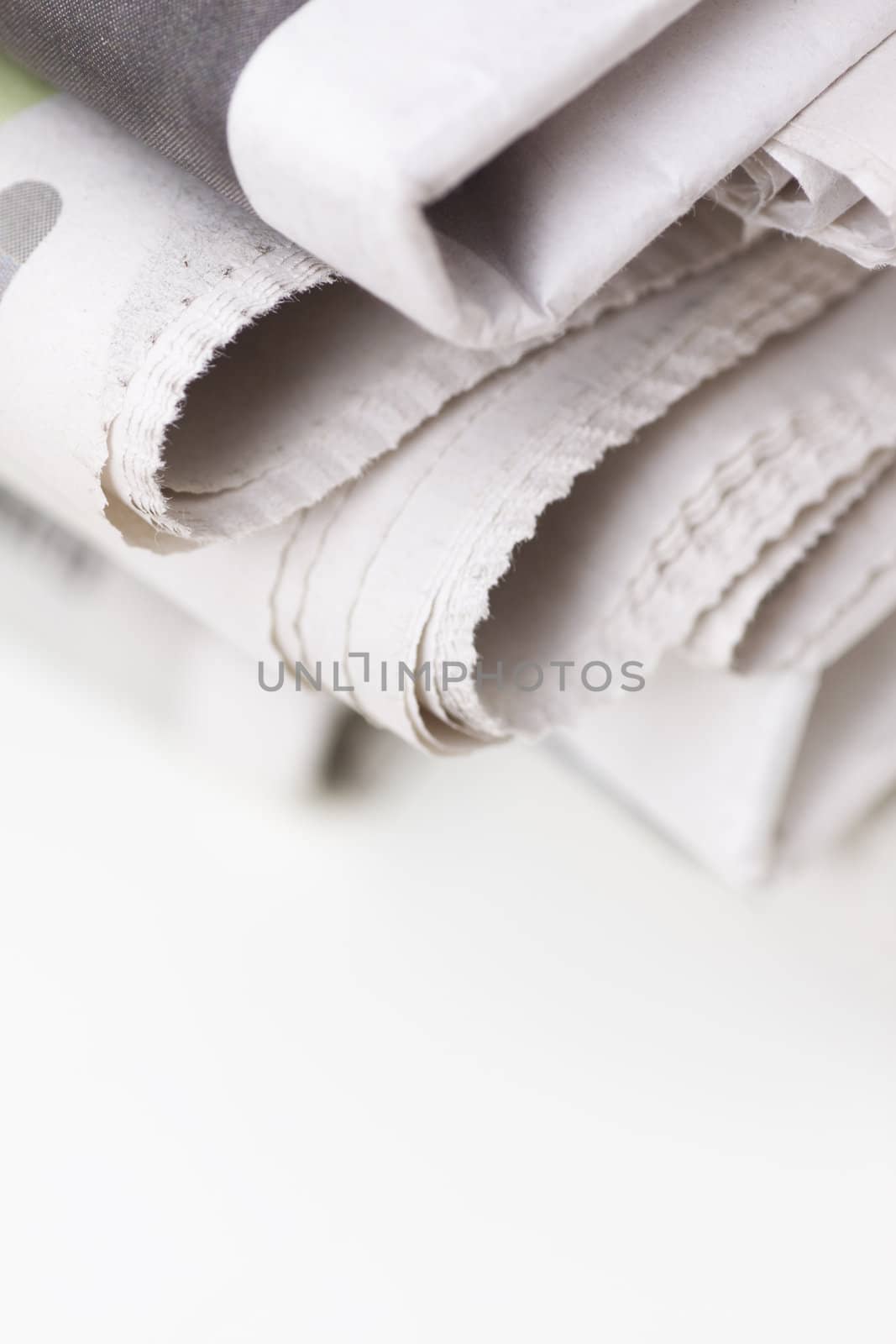 pile of newspapers on white table