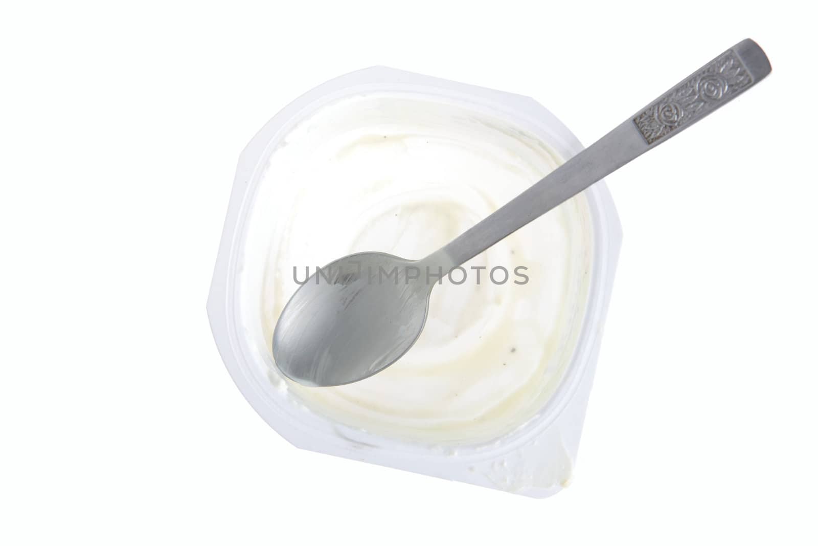 Empty yogurt with spoon by BDS