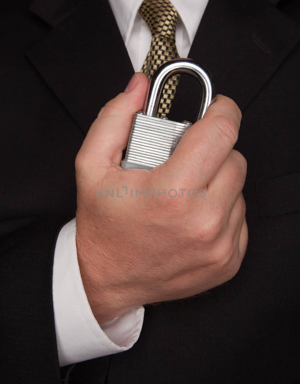 Businessman with Coat and Tie Holding Large Lock.