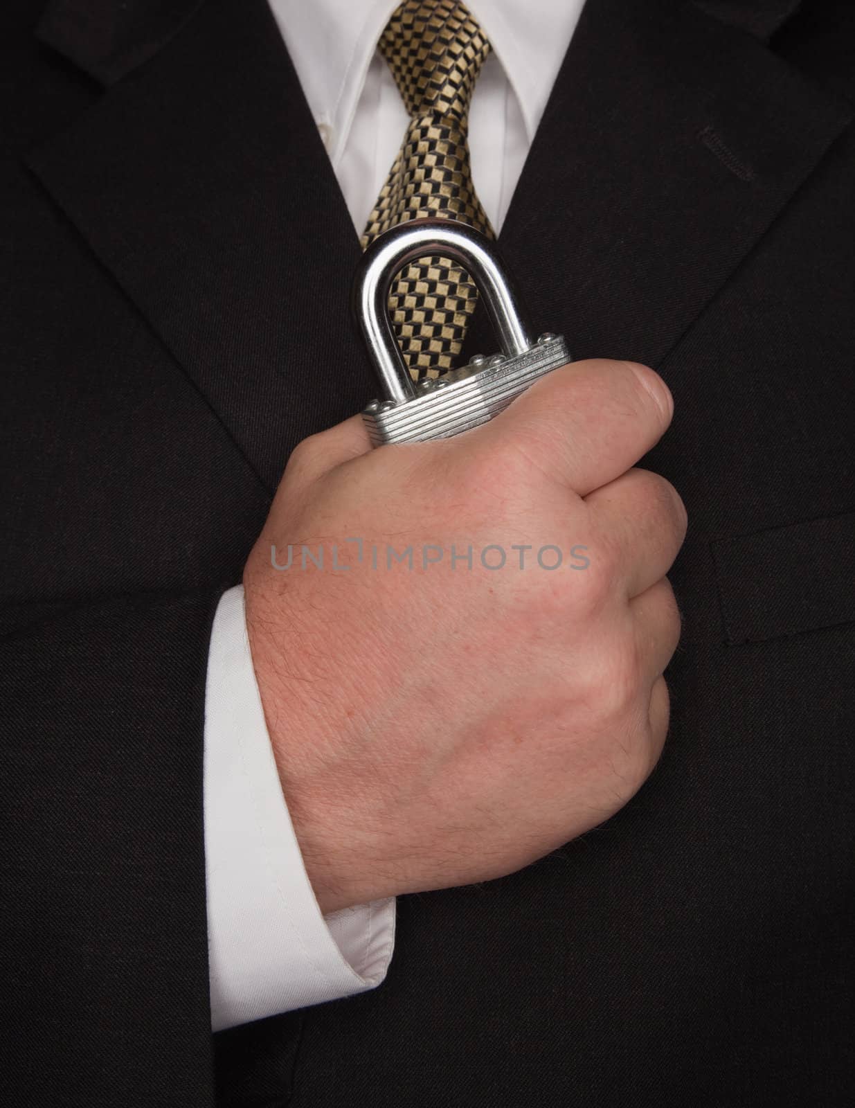 Businessman with Coat and Tie Holding Large Lock.