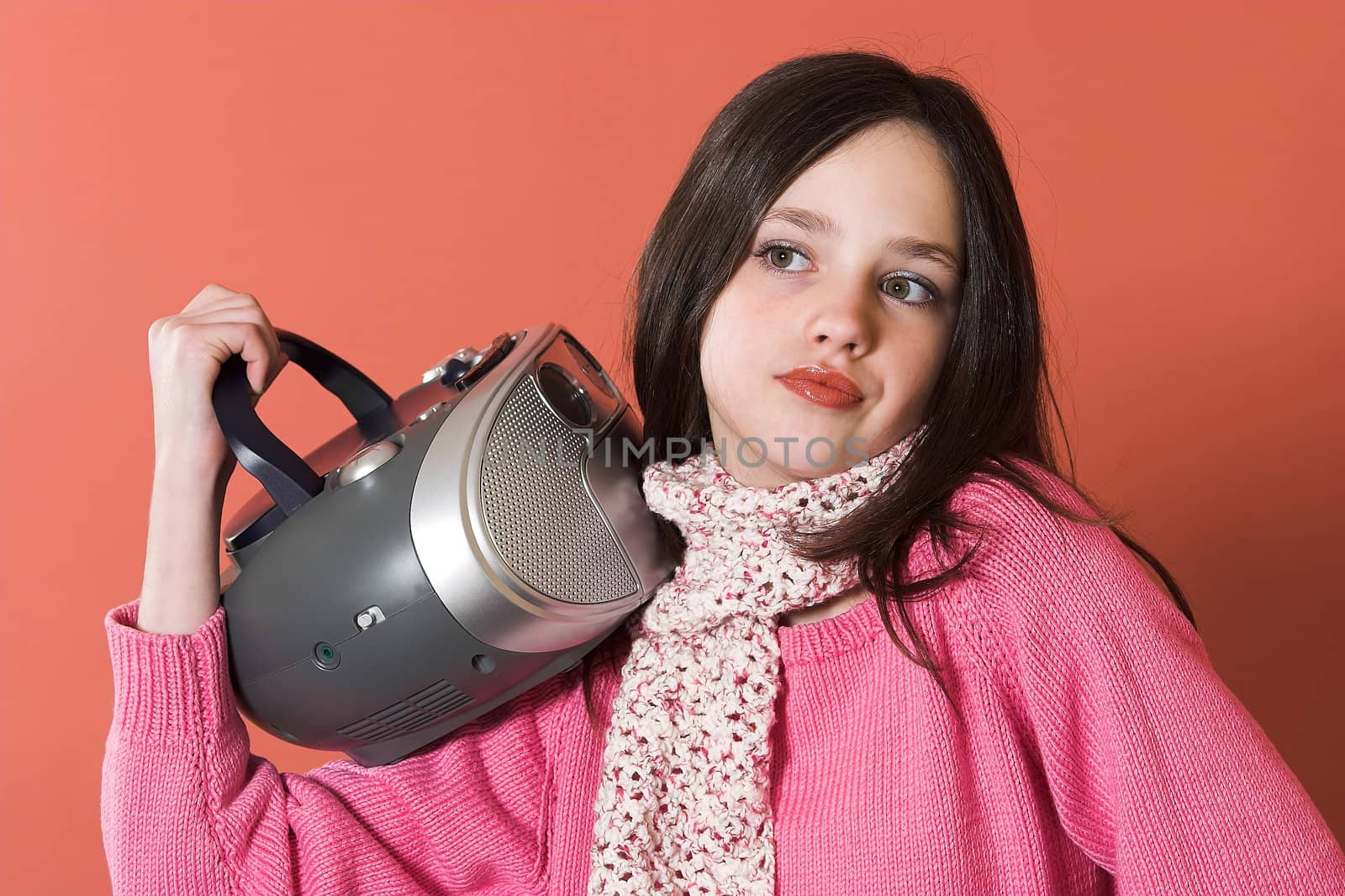 pretty girl listening music and holding portable CD radio