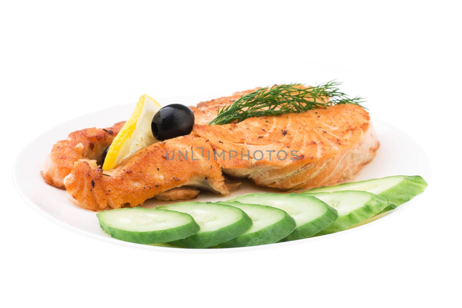Appetizing Grilled Salmon with sliced cucumber, lemon and black  by rozhenyuk