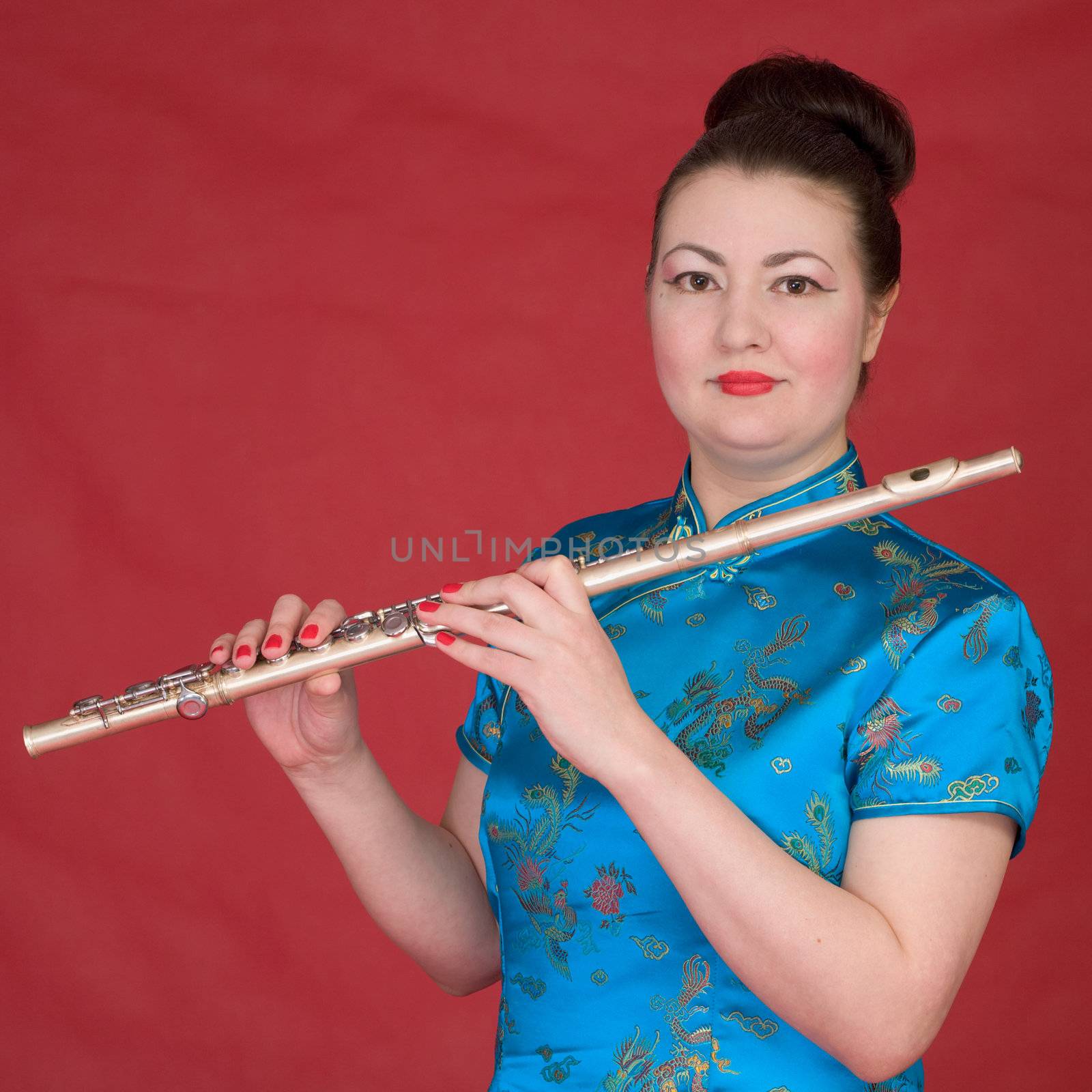 Japanese girl with flute on the red background