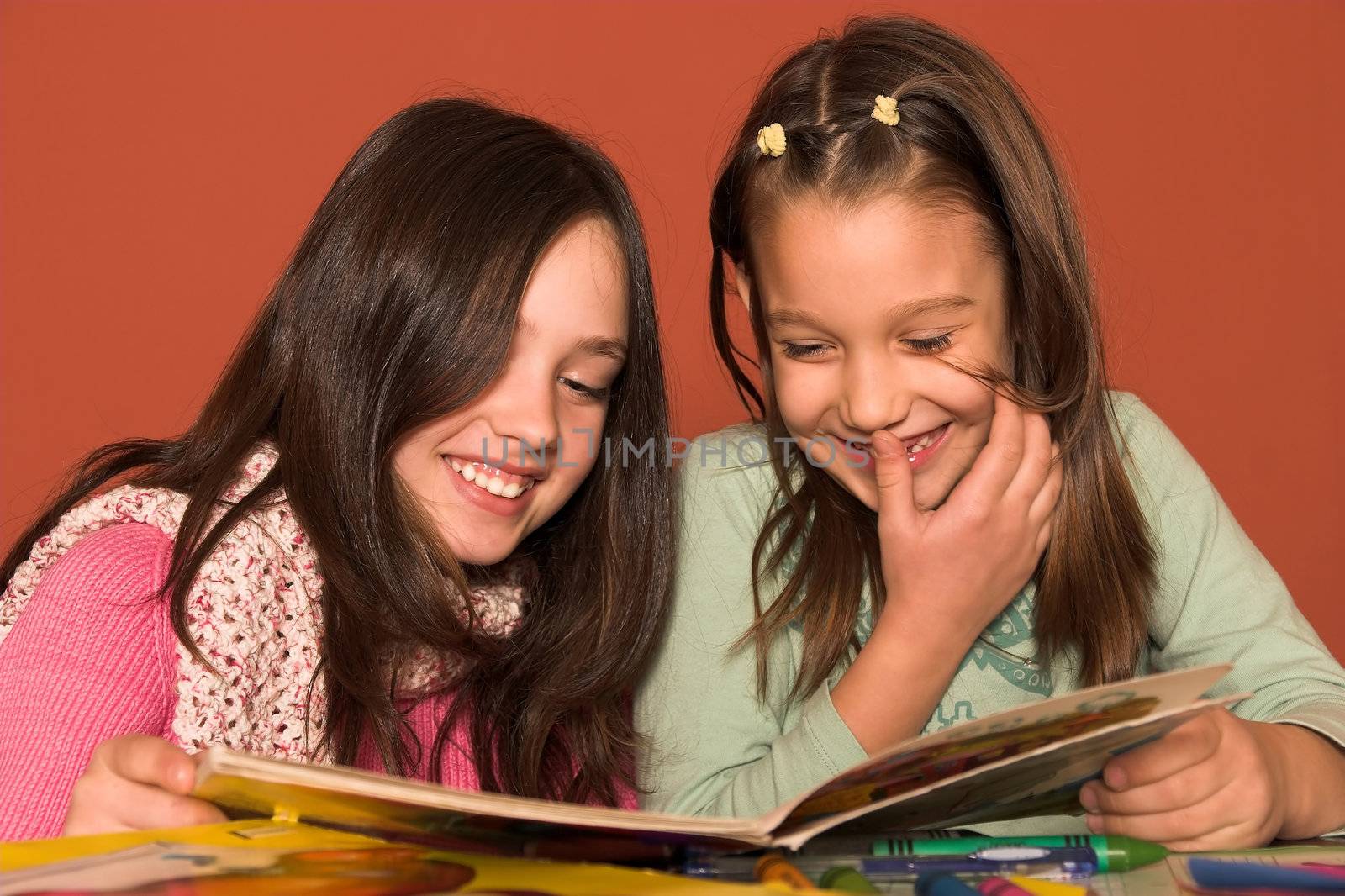 girls reading book in classroom