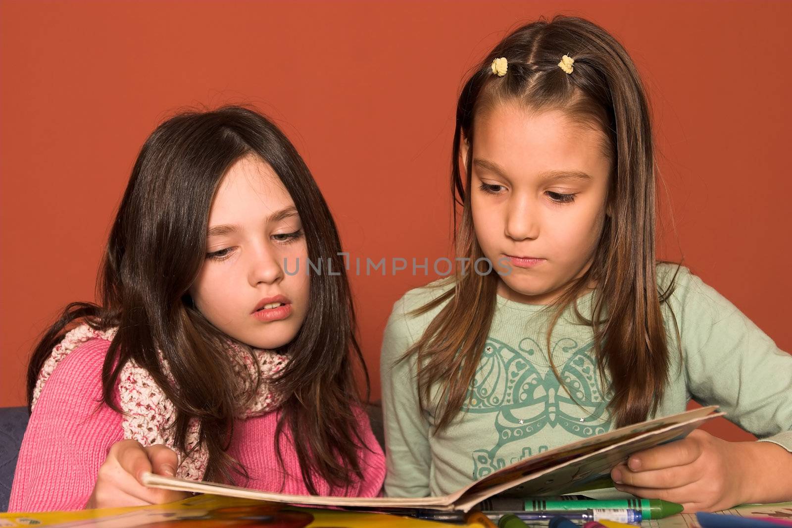 girls reading book in classroom by vladacanon