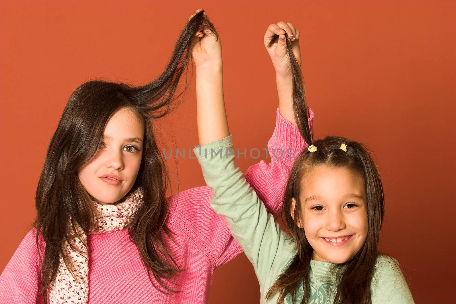 two pretty girls touching hair