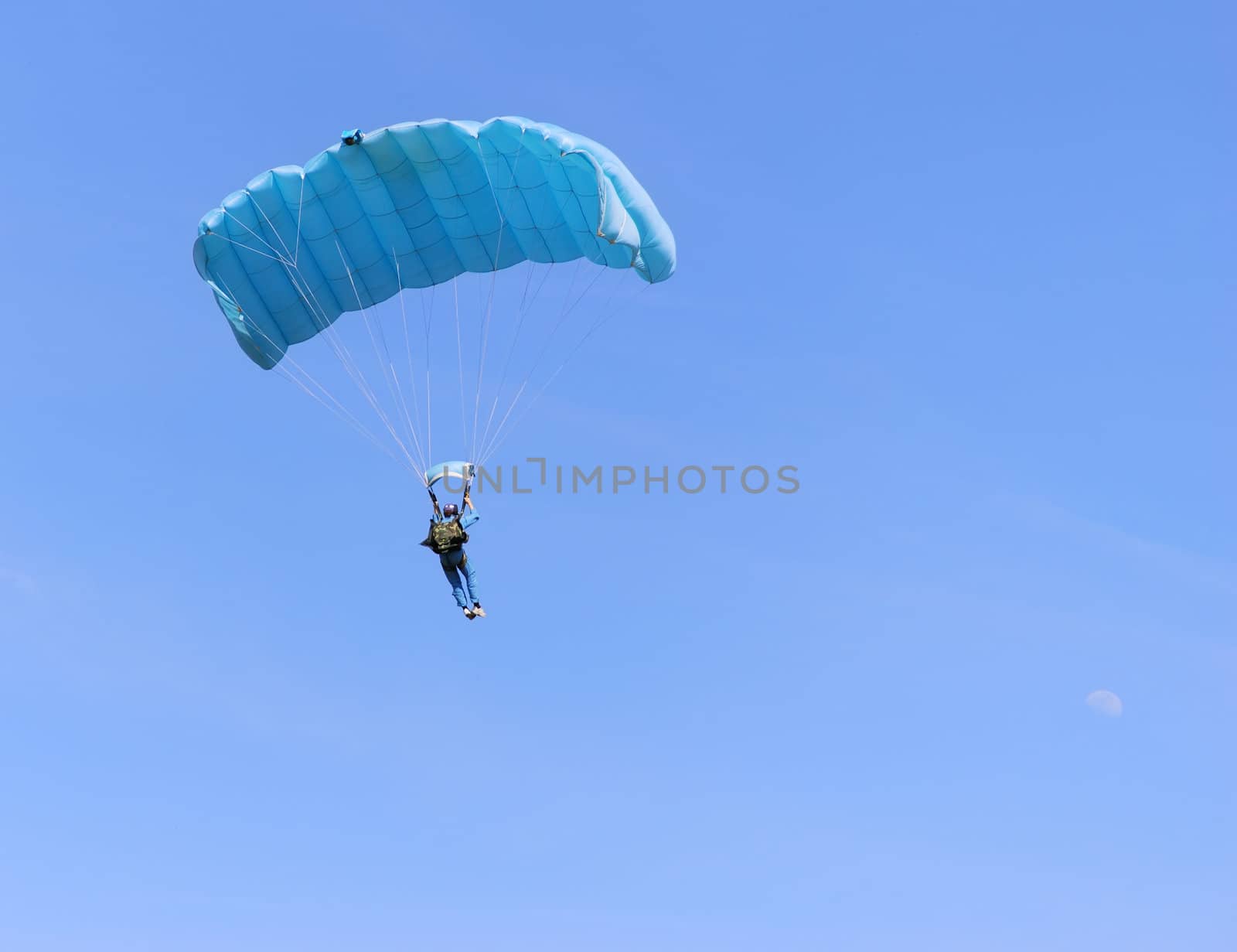 A blue parachute on a bright sunny day.