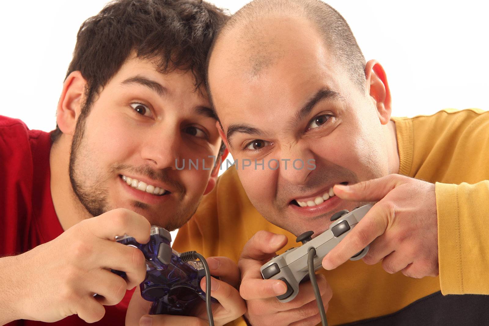 Two young men playing video game console controller by vladacanon