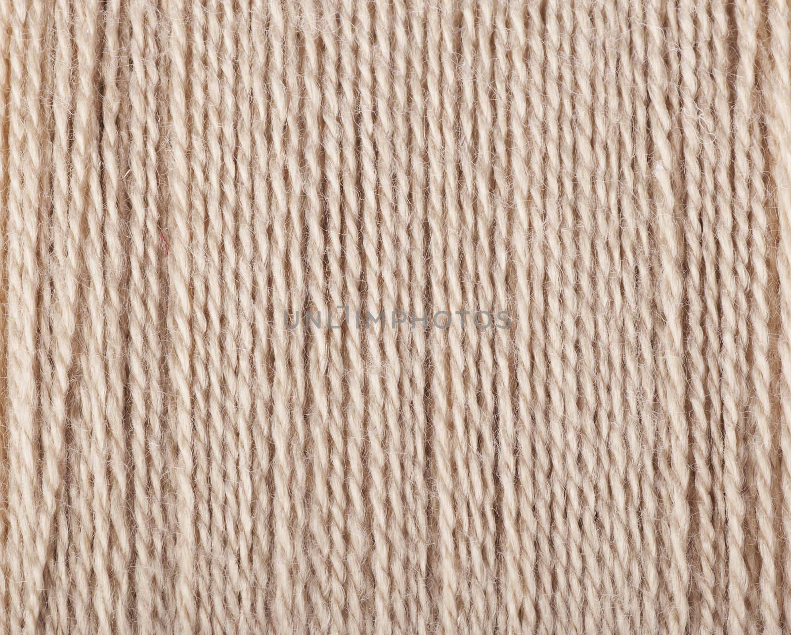 Tan threads ready for sewing or knitting.