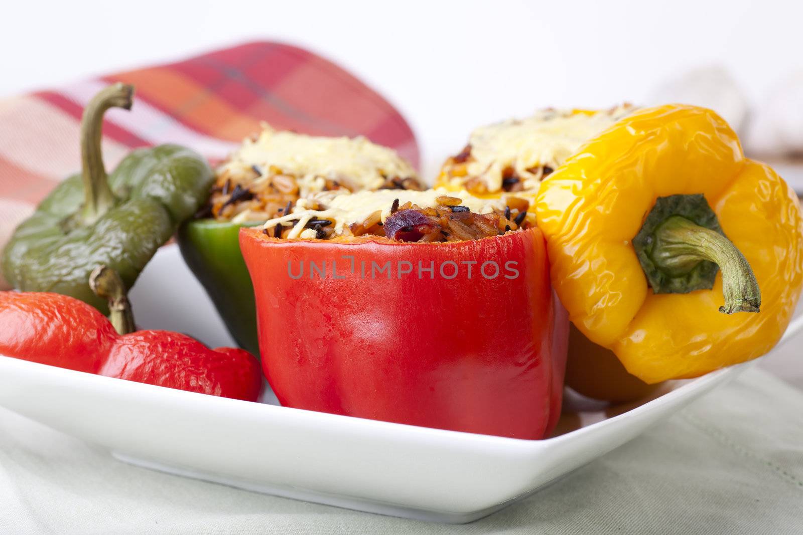 Stuffed red, yellow and green bell peppers.