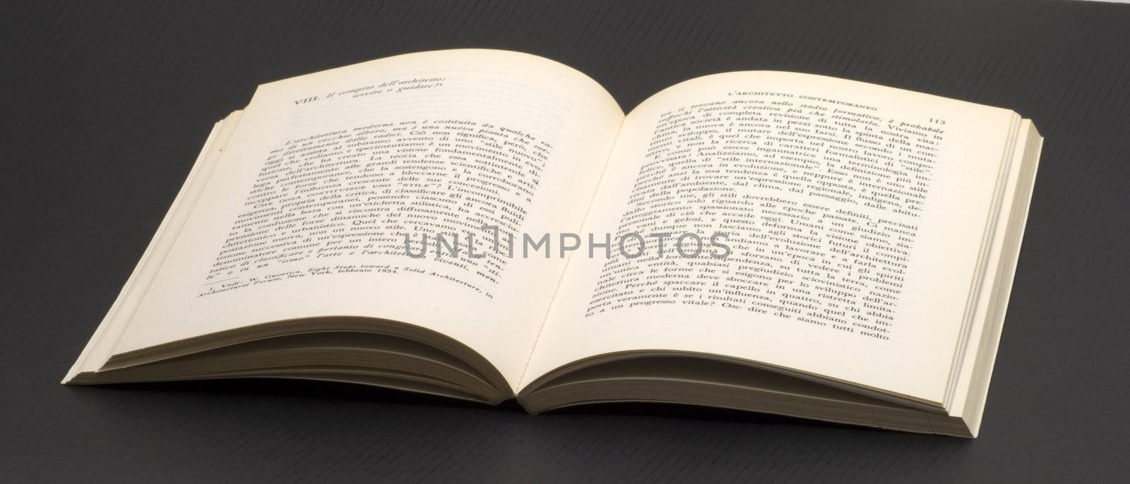 An open book on a black background