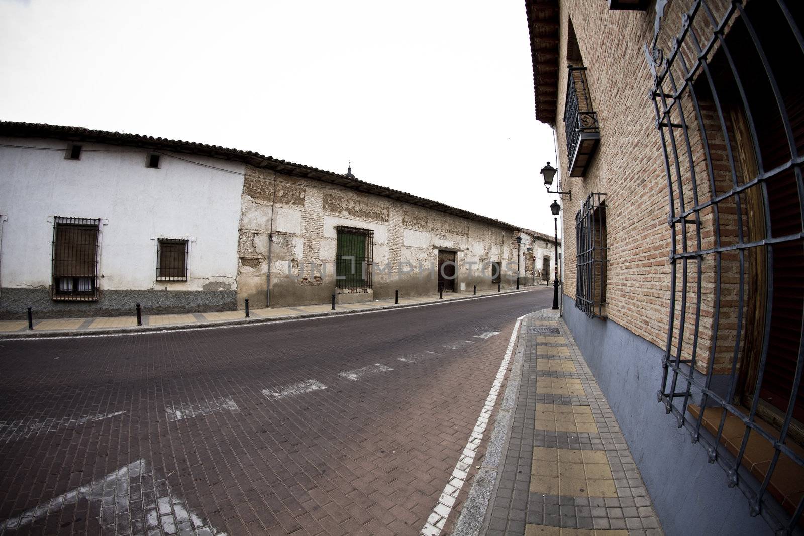 Street with houses made of mud, rural town by FernandoCortes