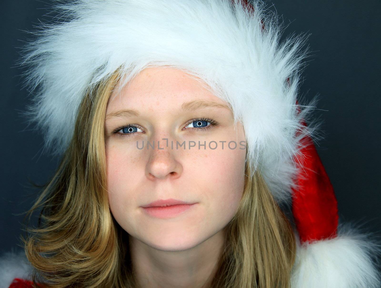 portrait of  a young beautiful woman in a santa claus costume - moody atmosphere