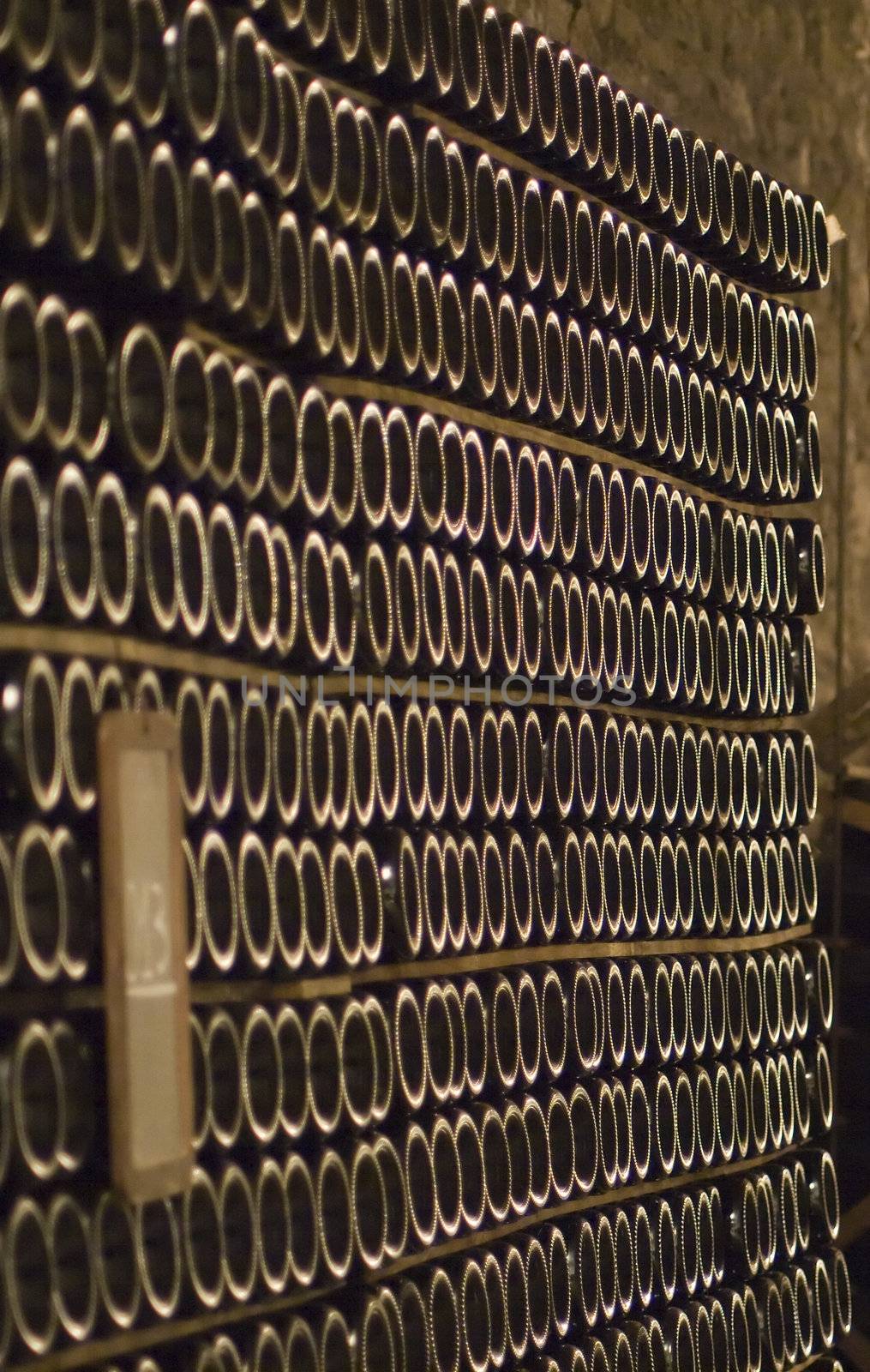 Closeup of bottles of wine aging in an old cellar