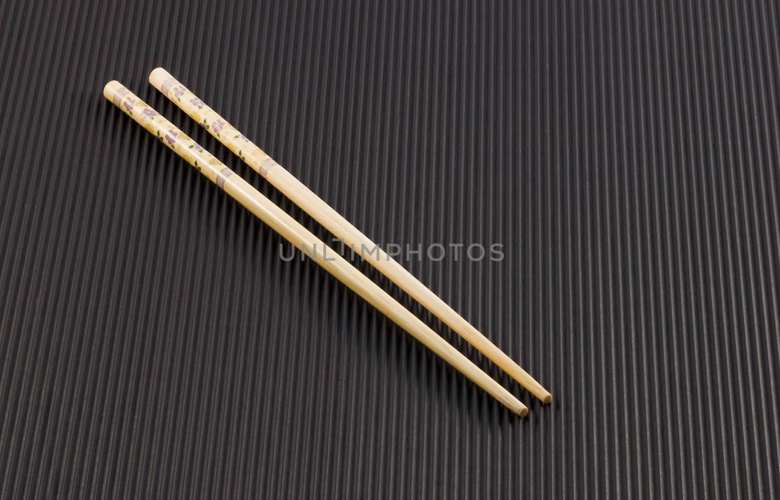 A pair of Chopsticks for Oriental food on black background