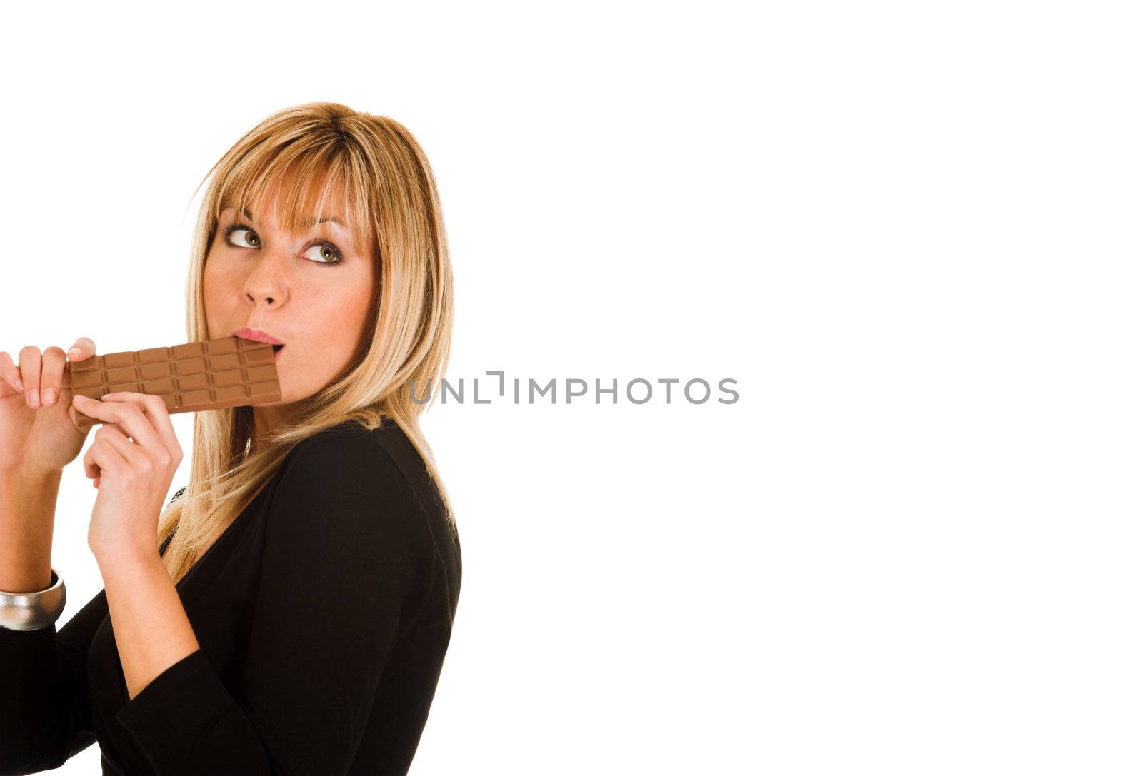 young girl eating chocolate on white background