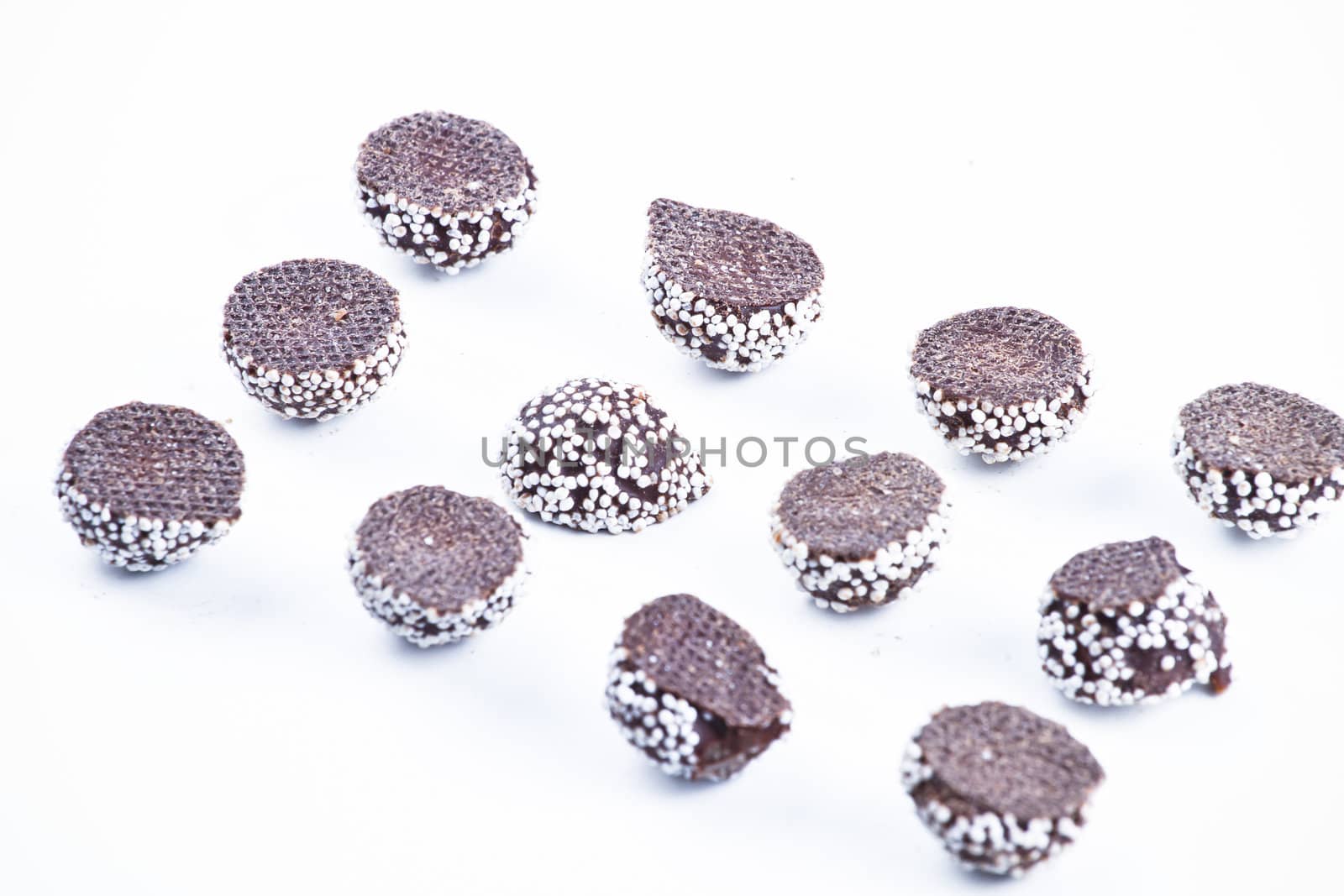 Delicious chocolate pralines over white background.