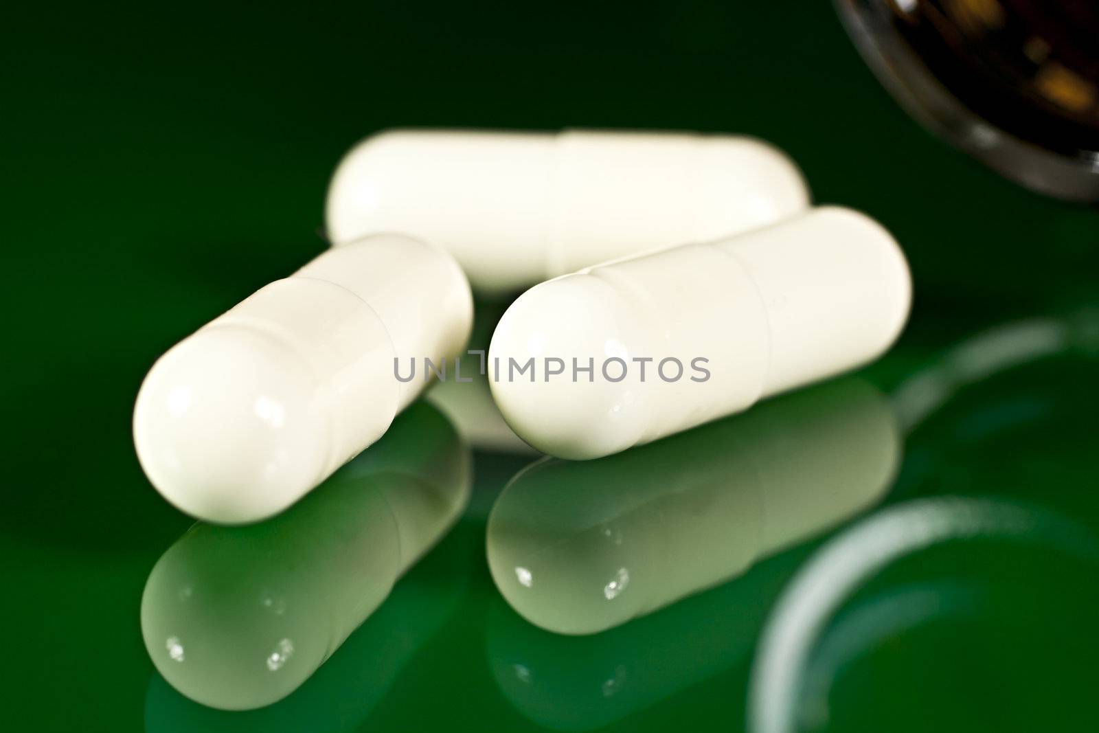 On a green background in the form of capsules open.