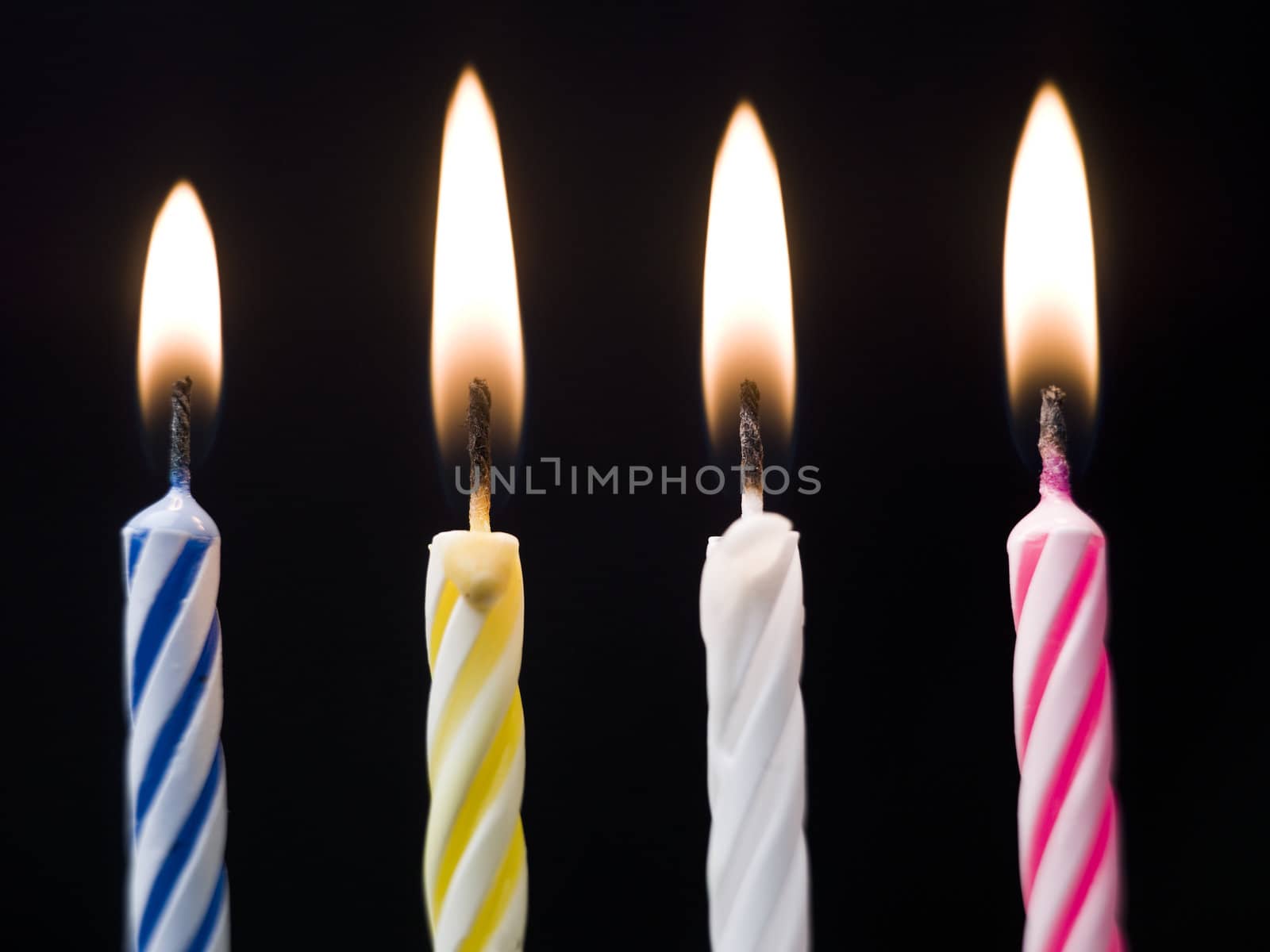 Burning Birthday Candles on black background