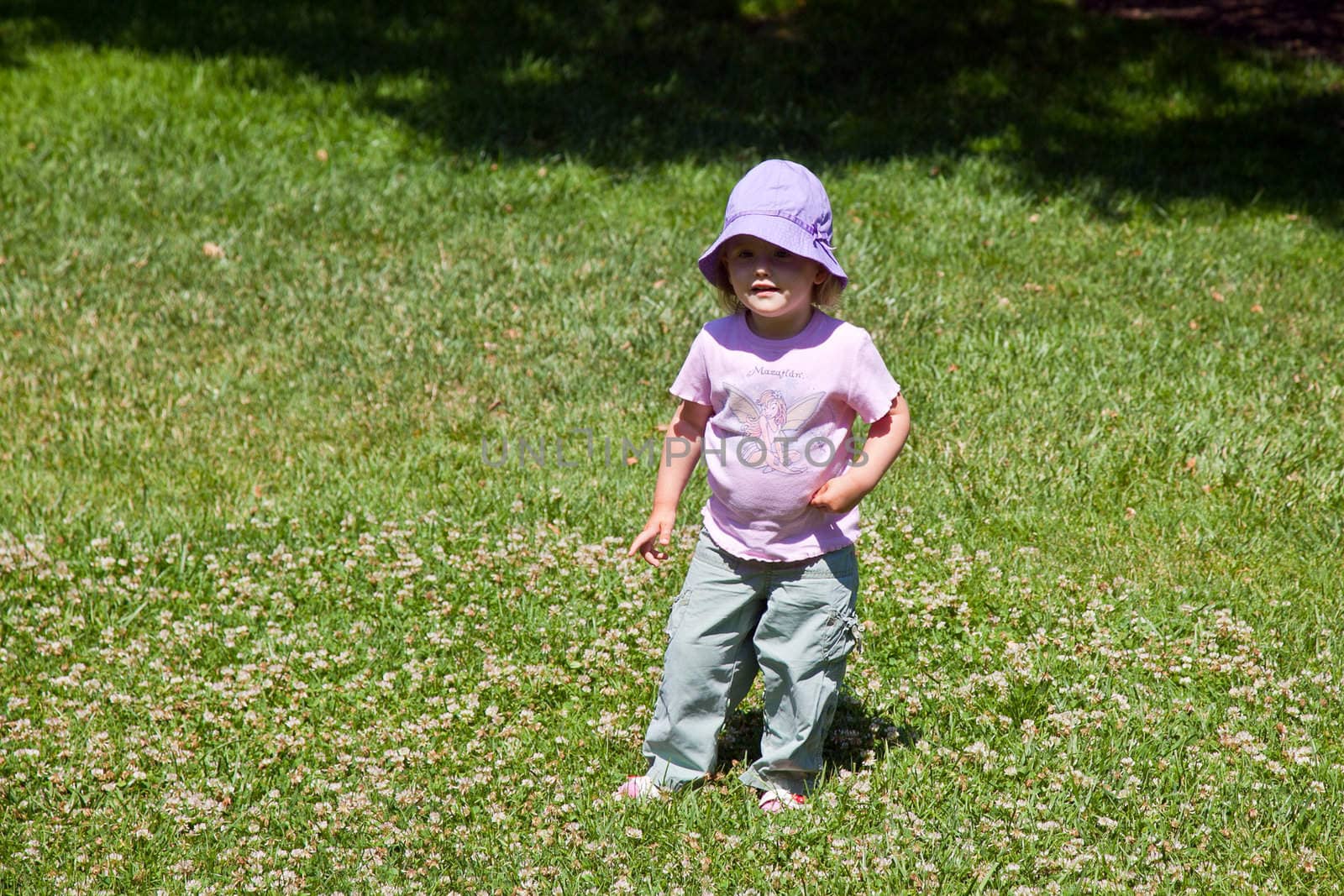 Cute little Caucasian baby girl walking in park