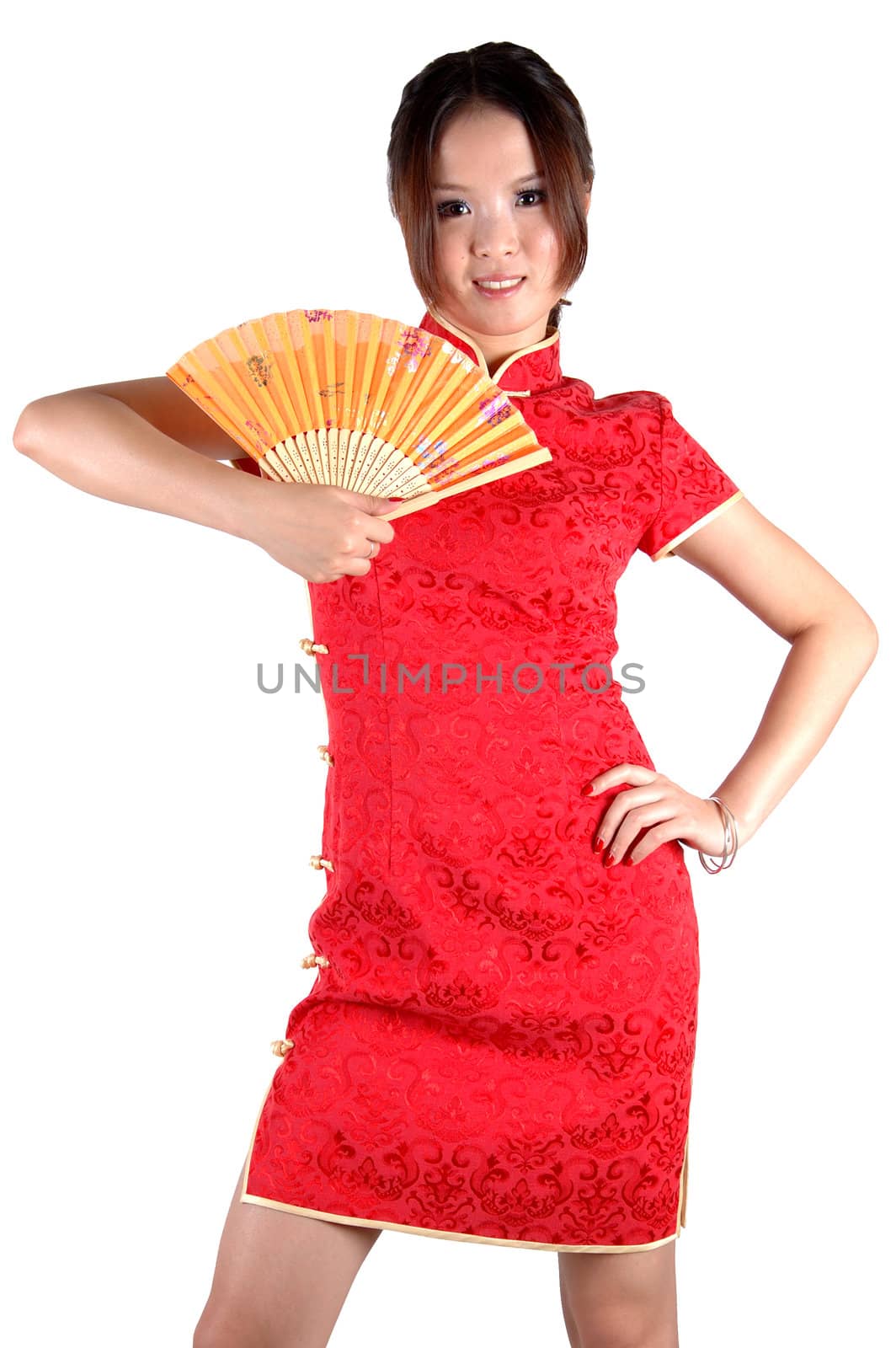 Chinese model in traditional dress called QiPao, holding fan. Asian cute girl, young model with friendly and happy face expression.