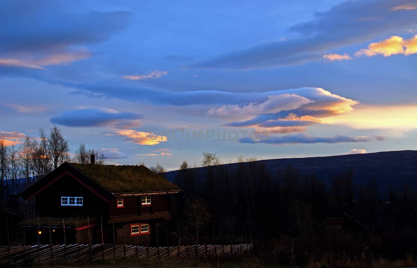 Mountain cabin in sunset