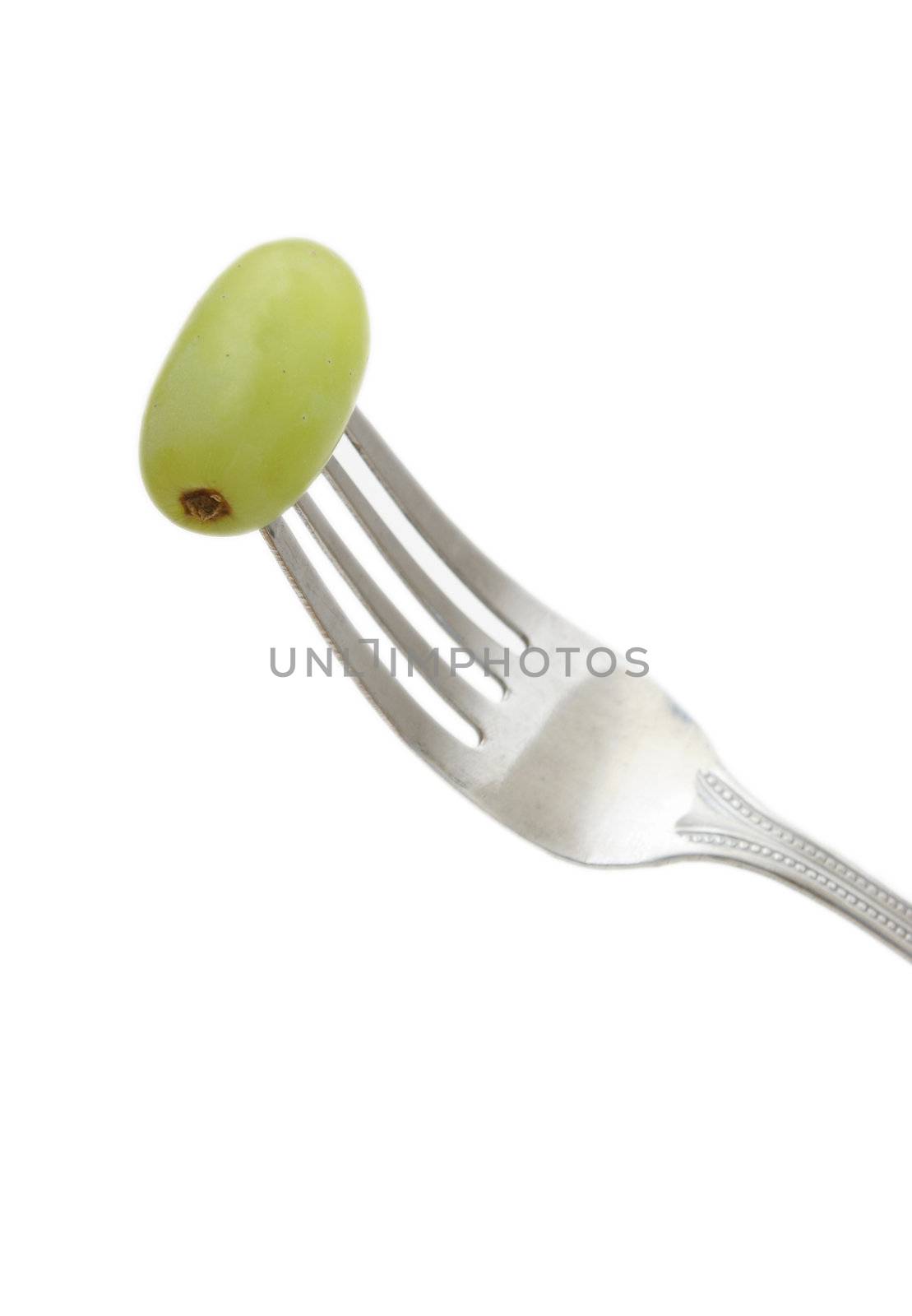 A fork with a grape on it to show healthy eating.