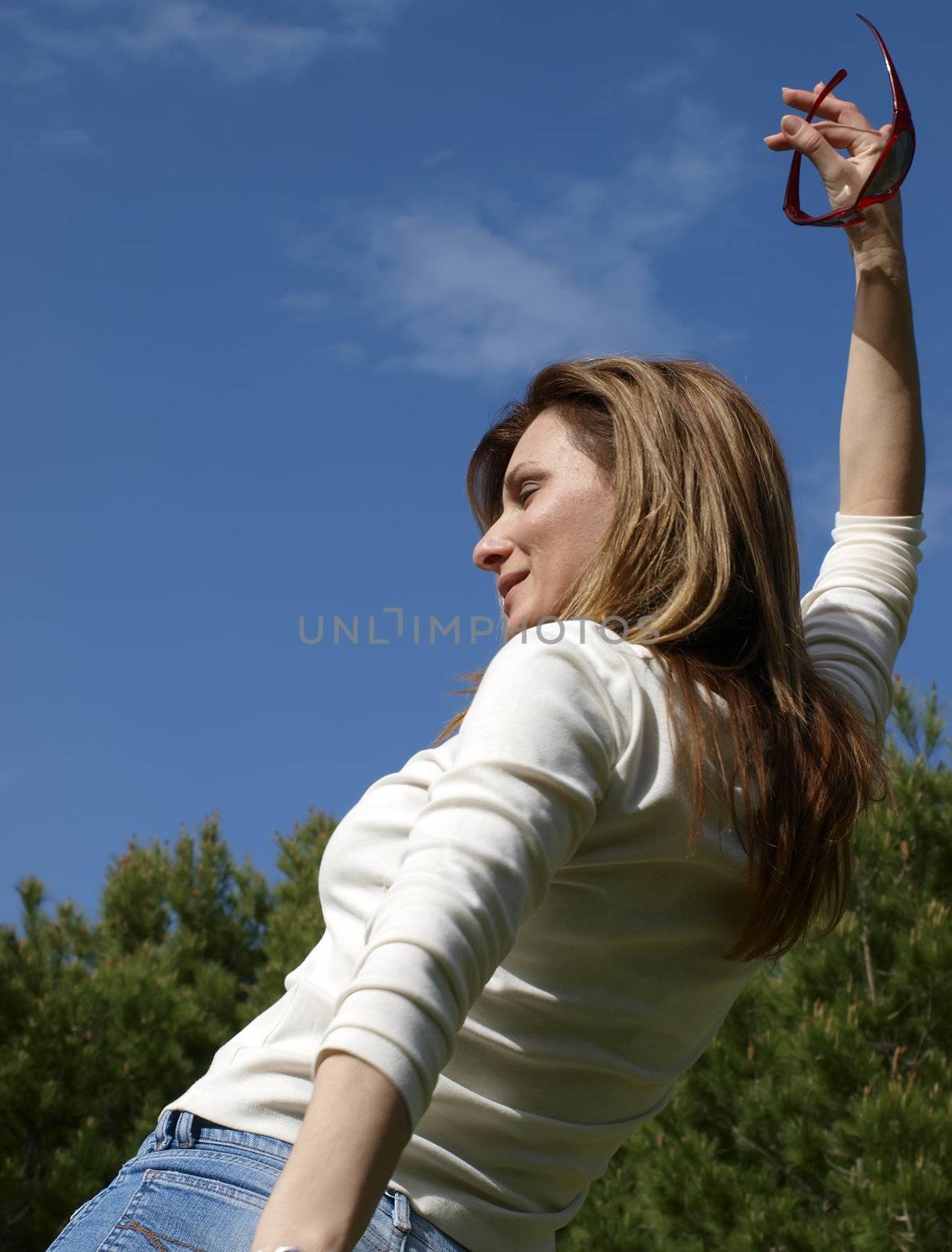 Woman in the countryside in a happy blissful mood